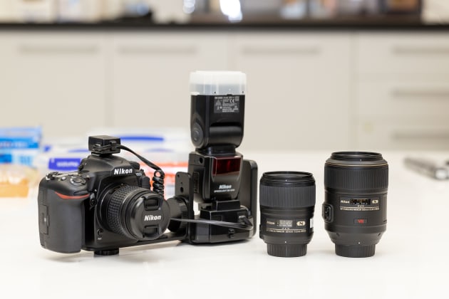 A typical camera kit for a crime scene photographer. Nikon D500 with a Nikon AF-P Nikkor 18-55 millimetre VR lens, SB5000 flash, as well as an AF-S Micro 60 millimetre VR lens and an AF-S Micro 105 millimetre VR lens.