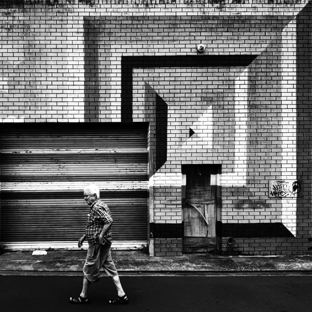 Geometric shapes captured in a Dulwich Hill laneway, complementing the checkered shirt of the passer by. Apple iPhone 15 Plus. 1/530s @ f2.4, ISO 25;