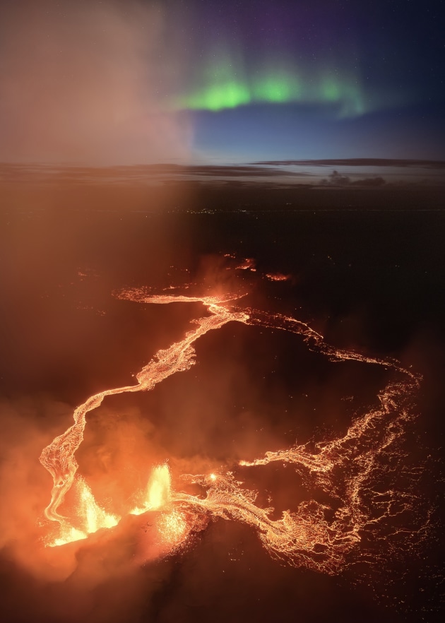 “Magic of the North” – Josh Beames, Iceland.
I’ve dreamed of capturing this shot for years, and this year, everything aligned perfectly! During my annual Iceland workshop, our group witnessed the sheer power of nature as Iceland’s most recent active volcano erupted just days before.
After spending hours shooting and soaking in the incredible scene, we started to wrap up and head back to the car. Then, to our amazement, the Northern Lights began dancing across the sky! I quickly launched the drone, sending it on a mission to capture this wild spectacle.