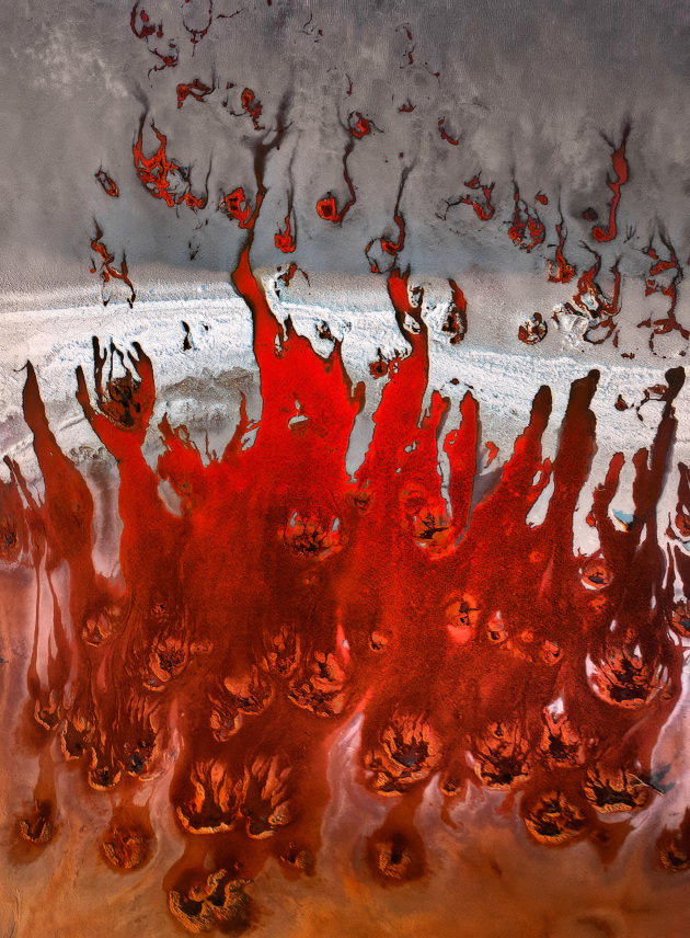 Salt Flames by Timothy Moon was taken over Lake Tyrrell in the Mallee District of Victoria. “The flow of groundwater into the salt lake along with the wetting and drying process lays up salts and displays the underlying iron rich red soils,” he says. DJI Mavic 2 Pro @ 26mm. 1/320s @ f5, ISO 100.