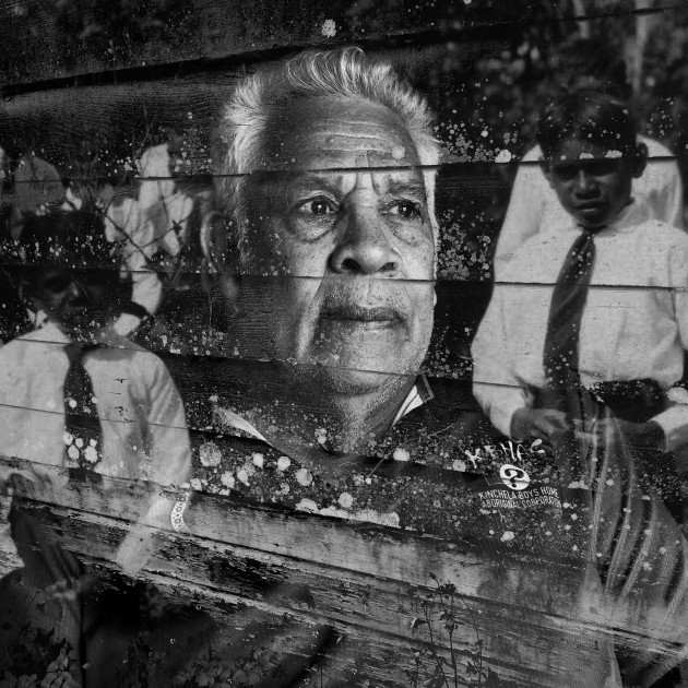 This double exposure portrait features Uncle Bobby ‘Bullfrog’ Young #24, taken in the old boys’ dormitory at the Kinchela Boys Home site, 4.5 hrs north of Sydney, Australia. The second layer is a photo of wooden slats that are part of the original structure of the weather shed. The third layer is an archival image, a group photo of some Kinchela Boys, that was provided by the Kinchela Boys Home Aboriginal Corporation.
“I’m a proud Gamilaroi man from up Quirindi. That’s where I was kidnapped at the age of 5. In 1954, my four siblings, we all got kidnapped.” Uncle Bobby ‘Bullfrog’ Young #24. Image: Tace Stevens for Magnum Foundation & World Monuments Fund.